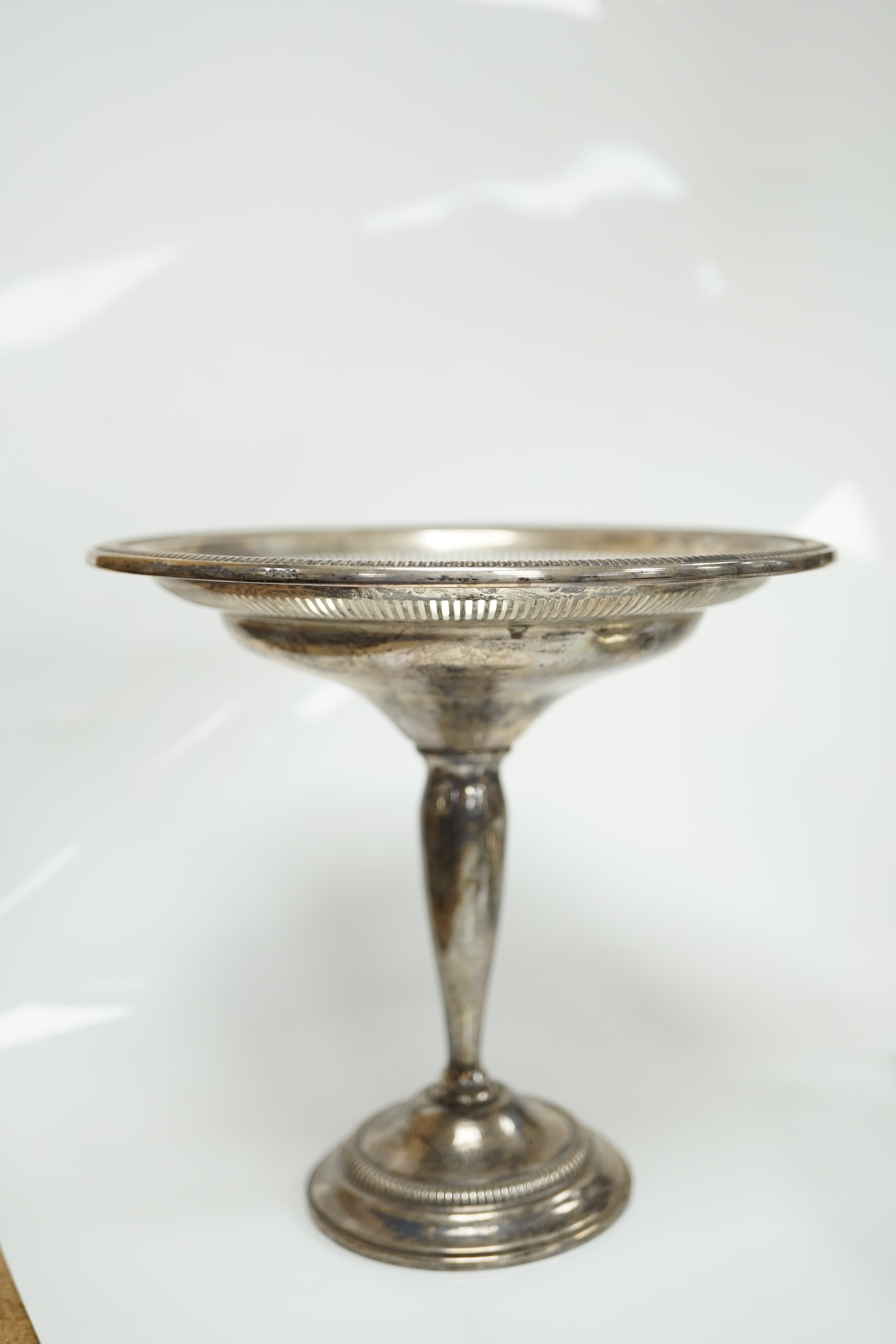 A George VI Art Deco silver two handled dish, Birmingham, 1939, 21.1cm, together with three assorted silver napkin rings, a modern silver sugar caster and a weighted sterling tazza. Condition - poor to fair